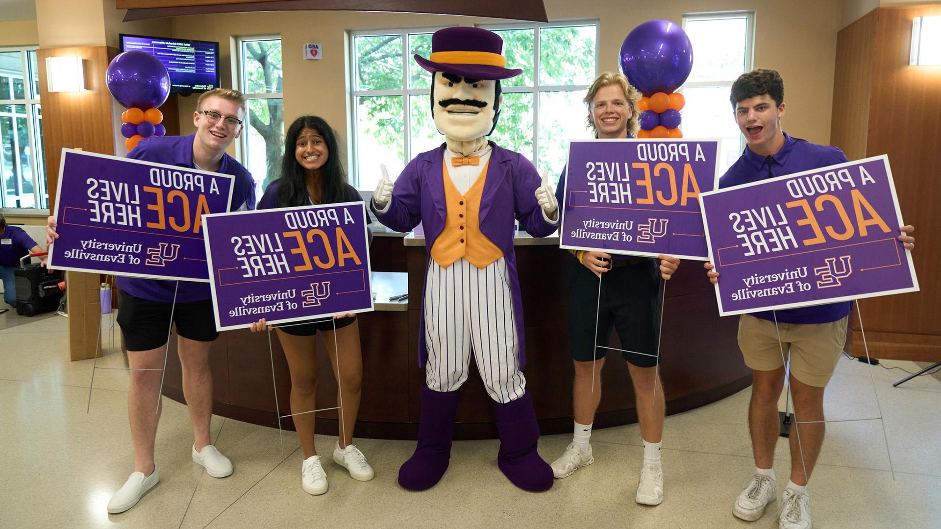 Ace Purple with students holding signs that say A Proud Ace Lives Here